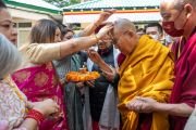 Его Святейшеству Далай-ламе подносят традиционное индийское приветствие по прибытии на празднование серебряного юбилея известной группы поддержки Тибета «Бхарат Тиббат Сахьог Манч». Дхарамсала, штат Химачал-Прадеш, Индия. 5 мая 2023 г. Фото: Тензин Чойджор (офис ЕСДЛ)