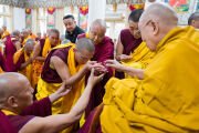 Фото: Его Святейшество Далай-лама вручает каждому из получивших полное монашеское посвящение небольшую статуэтку Будды в последний из четырех дней церемонии дарования обетов. Резиденция Его Святейшества Далай-ламы в Дхарамсале, штат Химачал-Прадеш, Индия. 3 марта 2026 г. Фото: Тензин Чойджор
